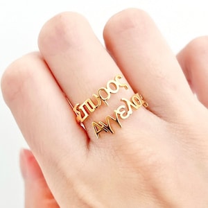 May include: Gold ring with the words "Amelia" and "Good" written on it.