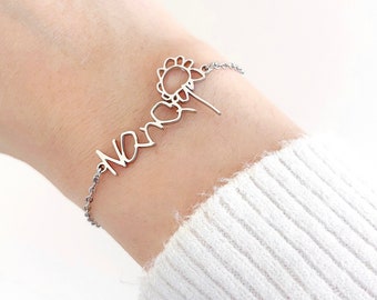 May include: A silver bracelet with the word "Never" written in cursive and a small sunflower charm.