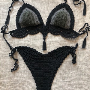 May include: A black and green crochet bikini top and bottom. The top has a triangle shape with a scalloped edge and ties at the neck and back. The bottom has a high-cut leg and ties at the sides.