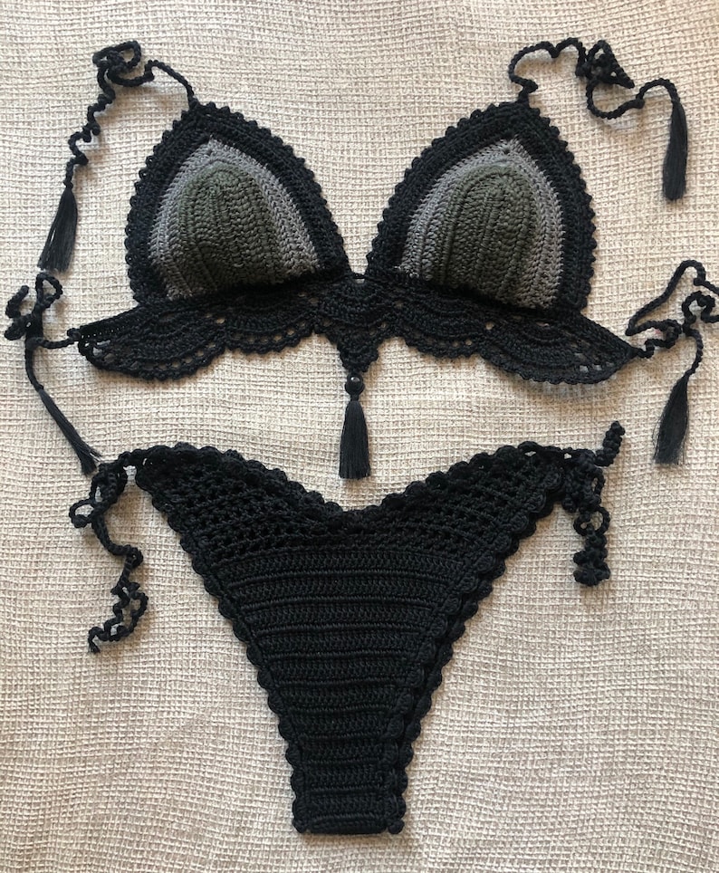 May include: A black and green crochet bikini top and bottom. The top has a triangle shape with a scalloped edge and ties at the neck and back. The bottom has a high-cut leg and ties at the sides.