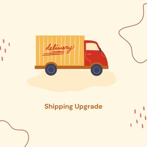 May include: Illustration of a red delivery truck with a yellow cargo area. The word "delivery" is written in cursive on the side. The text "Shipping Upgrade" is below the truck, all on a cream-colored background.