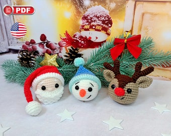 May include: Three crocheted Christmas ornaments: a snowman with a blue hat, a reindeer with brown antlers, and Santa Claus with a red hat and white beard.