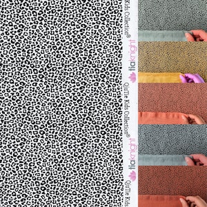 May include: A white fabric with a black leopard print pattern. Four fabric swatches are shown in different colours: mustard yellow, grey, rust orange, and a darker grey. The fabric swatches are labelled with the text "Our Tie Kids Collection®" and "tiddlybit".