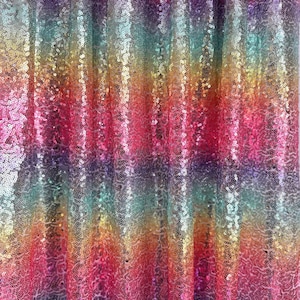 Puede incluir: Una tela brillante con un arcoíris de colores, desde el rosa hasta el morado, pasando por el naranja, el amarillo y el verde. La superficie está cubierta de pequeñas lentejuelas reflectantes, creando un efecto deslumbrante. Ideal para decoración.