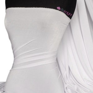 May include: White stretch knit fabric, a smooth and drapey material. The fabric is shown draped over a mannequin.