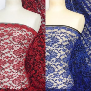 May include: Two pieces of black lace fabric with floral patterns. One piece is red and the other is blue.