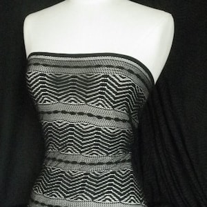 May include: Black and white geometric patterned fabric. The fabric has a zig-zag pattern with a white background and black lines.