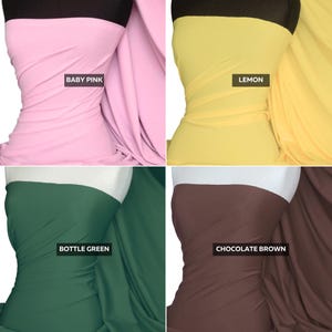 May include: A four-panel display of solid-colored fabric draped over a mannequin form. The colors shown are baby pink, lemon yellow, bottle green, and chocolate brown. Each section includes a black label identifying the specific color name.