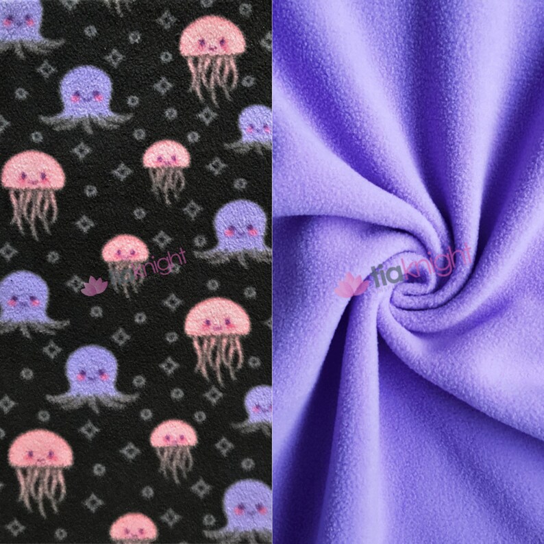 May include: Two pieces of fabric, one black with a repeating pattern of pink and purple jellyfish, and the other a solid light purple.