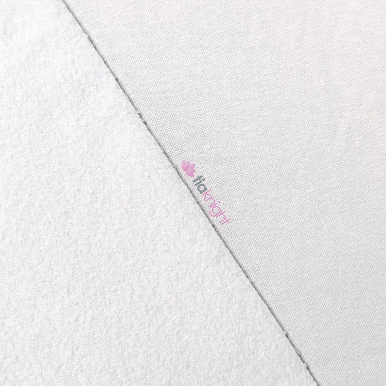 May include: A close-up of two white fabric samples. One side is a textured, terry cloth material, and the other is a smooth, woven fabric. The brand name "tiaknight" is printed in pink on the woven fabric.