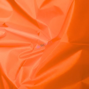 May include: Bright orange fabric with a subtle grid pattern. The material is tightly woven and appears to be lightweight, with soft folds and creases. The fabric has a smooth, slightly shiny surface.