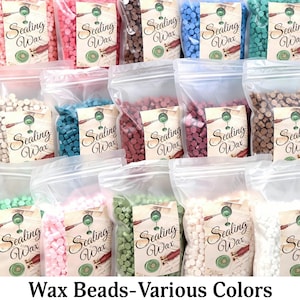 May include: Multiple clear plastic bags filled with small, round sealing wax beads in a wide variety of colors including pink, blue, brown, green, red, white, and cream. Each bag features a label with the text Sealing Wax and a graphic illustration.