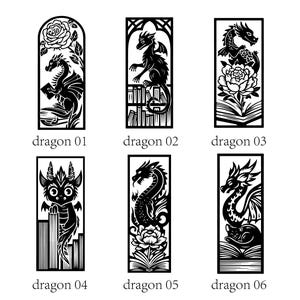 May include: Six rectangular black and white laser-cut designs featuring dragons. Dragon 01 shows a dragon with a rose, 02 with books, 03 with a flower and book, 04 with books, 05 with a flower and book, and 06 with a cat and book.