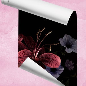 May include: A close-up of a dark red lily with white spots, surrounded by purple and blue flowers on a black background. The image is partially obscured by a white sheet of paper.