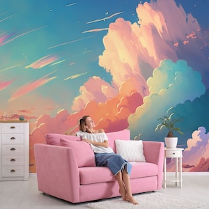 May include: A woman relaxes on a pink sofa in front of a wall mural depicting a colourful sunset sky with clouds.
