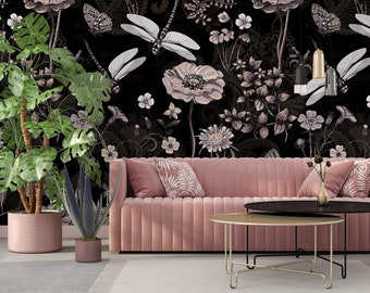 May include: A pink velvet sofa with a black and gold coffee table in front of it. The sofa is in front of a black wall with a floral pattern featuring dragonflies and flowers.