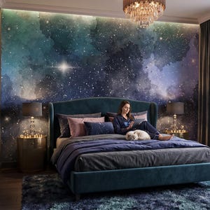 May include: A bedroom featuring a large wall mural of a deep blue and green galaxy with scattered white stars. The room includes a dark teal upholstered bed, a plush blue rug, two gold bedside tables with lamps, and a crystal chandelier above.