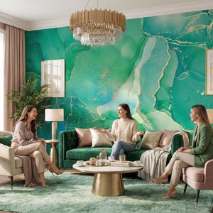 May include: A living room featuring a large emerald green and gold marble-patterned wall mural, a tufted dark green sofa, a cream armchair, a pink velvet chair, a round marble coffee table with a gold base, and a gold tiered crystal chandelier.