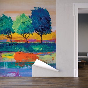 Może przedstawiać: Abstrakcyjne malowidło przedstawiające trzy drzewa z niebieskimi, zielonymi i ż&oacute;łtymi liśćmi na kolorowym tle. Obraz znajduje się na ścianie w pokoju z kanapą i stolikiem kawowym.