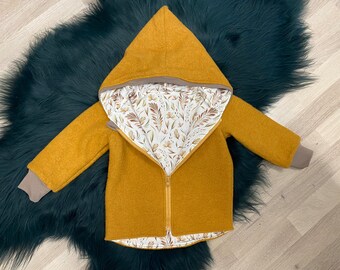 May include: A mustard yellow hooded jacket with a zipper closure and a floral print lining. The jacket has a soft, cozy feel and is perfect for keeping warm in the colder months.