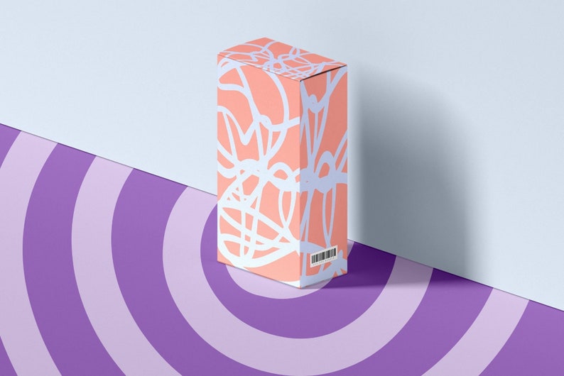 May include: A pink box with a white abstract design. The box is sitting on a purple and white striped surface.