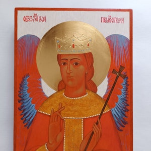 May include: A hand-painted icon of an angel with wings, wearing a gold crown and a red robe. The angel is holding a staff with a cross on top. The icon is on a wooden panel with the words "Образ Божий" and "Пресвятой" written in red.