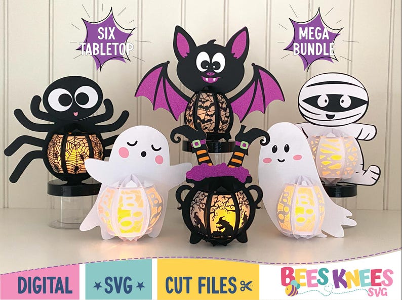 May include: Six Halloween-themed tabletop light-up decorations. The decorations include a spider, a ghost, a witch's cauldron, a bat, a mummy, and another ghost. Each decoration has a light-up pumpkin inside. The text "Six Tabletop" and "Mega Bundle" are visible in the image.