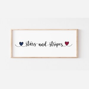 May include: A framed print with the text "stars and stripes" in black cursive font. The text is flanked by two hearts, one blue and one red.