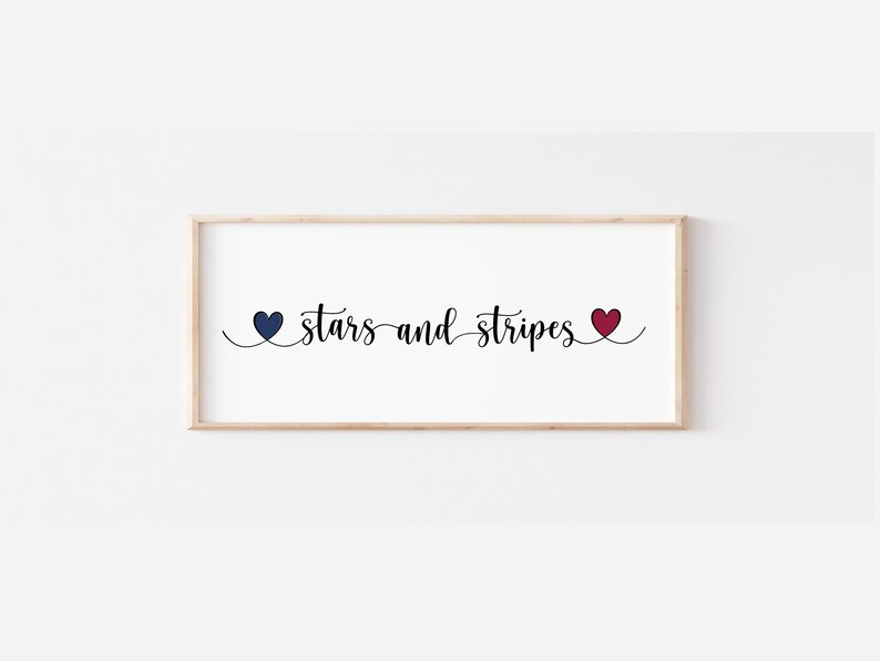 May include: A framed print with the text "stars and stripes" in black cursive font. The text is flanked by two hearts, one blue and one red.