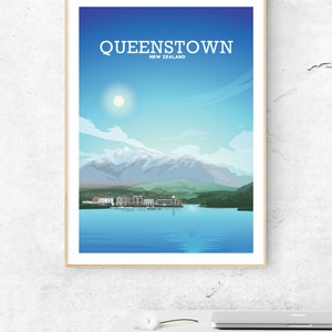 May include: A framed illustration of Queenstown, New Zealand, with a blue sky, white clouds, a sun, mountains, a lake, and a town.