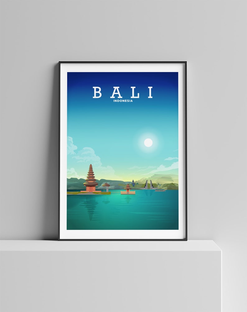 May include: A poster with a minimalist design featuring a temple on a body of water with a blue sky and white sun. The text "BALI INDONESIA" is at the top of the poster.