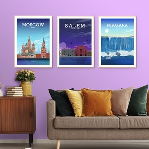 May include: Three framed prints of cityscapes. The left print shows the St. Basil's Cathedral in Moscow, Russia. The middle print shows a red building in Salem, Massachusetts, USA. The right print shows Niagara Falls.