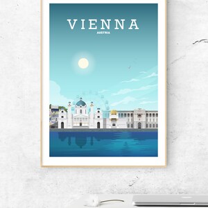 May include: A framed illustration of the Vienna skyline, featuring a white building with a dome, a Ferris wheel, and a blue sky with a white sun. The text "VIENNA" and "AUSTRIA" is printed in black at the top of the image.