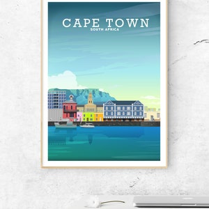 May include: A colourful illustration of the Cape Town skyline, featuring the iconic Table Mountain, a harbour with boats, and colourful buildings. The text "CAPE TOWN" and "SOUTH AFRICA" is displayed at the top of the image.