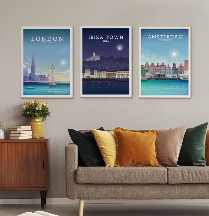 May include: Three framed travel art prints featuring cityscapes of London, Ibiza Town, and Amsterdam. The London print shows the Shard and Tower Bridge. The Ibiza Town print depicts a nighttime scene. The Amsterdam print shows colorful buildings.