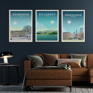 May include: Three framed city skyline posters with a brown leather couch in the foreground. The posters are of Edinburgh, Scotland, Killarney, Ireland, and Birmingham, United Kingdom.