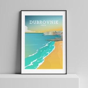 May include: Framed art print featuring a coastal scene of Dubrovnik, Croatia. The artwork depicts a beach with turquoise waves, a golden sand shore, and a city skyline under a blue and yellow sky. The word "Dubrovnik" is printed at the top.