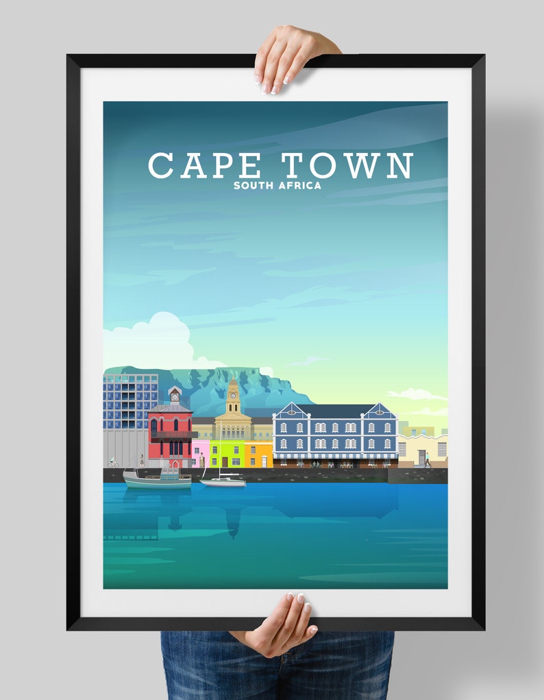 May include: A colourful illustration of the Cape Town skyline, featuring a waterfront with boats, buildings, and Table Mountain in the background. The text "CAPE TOWN" and "SOUTH AFRICA" is displayed at the top of the image.