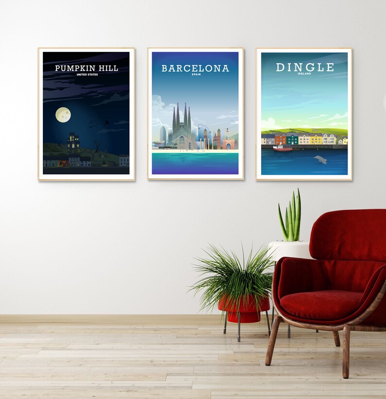 May include: Three framed city skyline posters with the names "Pumpkin Hill, United States", "Barcelona, Spain", and "Dingle, Ireland" printed on them. The posters are hanging on a white wall above a red armchair and two potted plants.