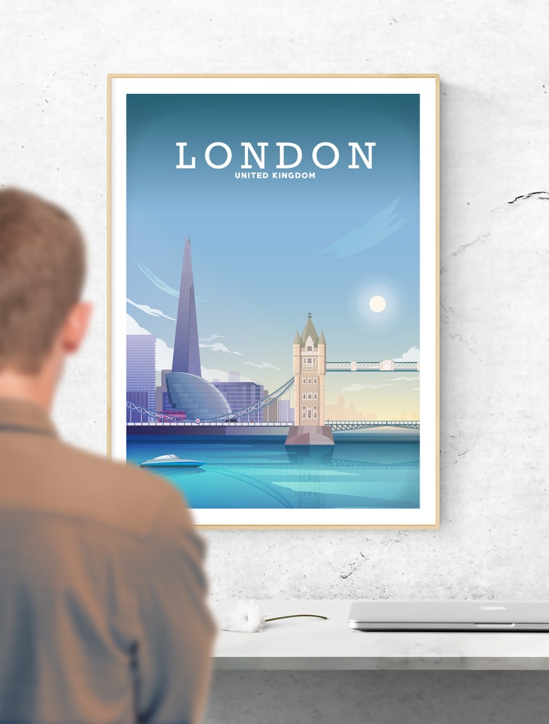 May include: A framed poster with a blue and white illustration of the London skyline, including the Tower Bridge, the Shard, and the River Thames. The poster has the text "LONDON" and "UNITED KINGDOM" printed on it.