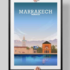 May include: A colorful illustration of the city of Marrakech, Morocco. The illustration features a minaret, a building with a dome, palm trees, and a reflecting pool. The text "MARRAKECH MOROCCO" is at the top of the image.