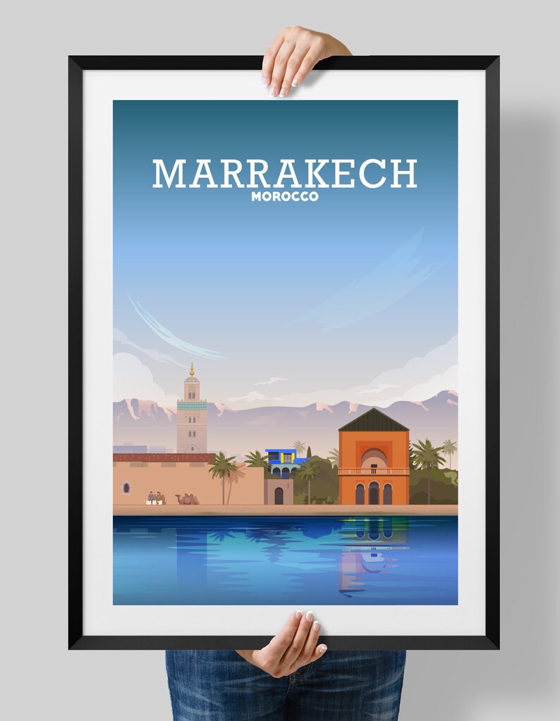 May include: A colorful illustration of the city of Marrakech, Morocco. The illustration features a minaret, a building with a dome, palm trees, and a reflecting pool. The text "MARRAKECH MOROCCO" is at the top of the image.