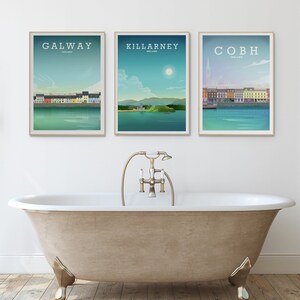 May include: Three framed prints of Irish cities, Galway, Killarney, and Cobh, with a white background and a bathtub in the foreground.