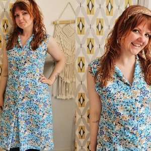 May include: A sleeveless dress with a blue, white, and brown floral pattern. The dress has a collared neckline and a button-up front.