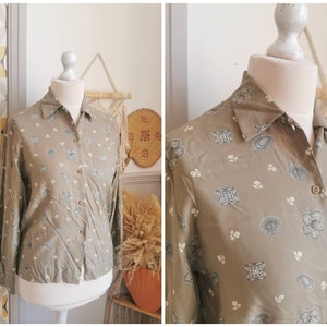 May include: A long-sleeved, button-down shirt with a paisley print in shades of green and white.