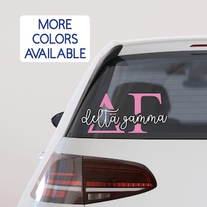 May include: Pink Delta Gamma sorority decal for a car window. The decal features the Greek letters Delta Gamma and the words "delta gamma" in cursive.