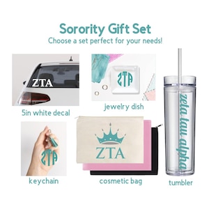 May include: A sorority gift set featuring a 5-inch white ZTA car decal, a square jewelry dish with a ZTA monogram, a circular ZTA keychain with a tassel, a set of three cosmetic bags, and a clear tumbler with a straw labeled Zeta Tau Alpha.