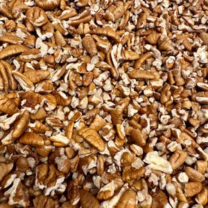 May include: A white ceramic mug with a black handle and the text "But First, Coffee" in a handwritten style. The mug is on a white surface. The mug is approximately 4 inches tall.