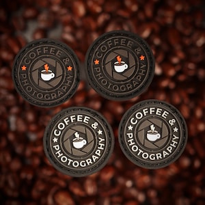 May include: Four black and white round patches with the text "Coffee & Photography" and a stylized image of a coffee cup inside a camera lens. The patches have a white border and a black background.