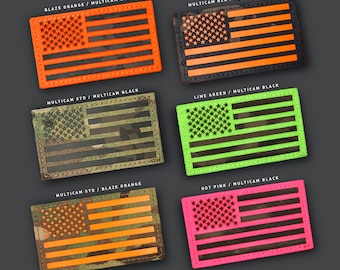 May include: A selection of rectangular patches featuring an American flag design in various colours. The patches include blaze orange, black, lime green, and hot pink, with text labels such as "BLAZE ORANGE / MULTICAM BLACK".
